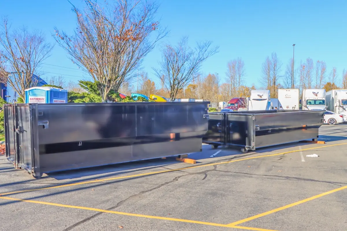 Professional dumpster rental service with roll-off container on residential driveway in Niagara